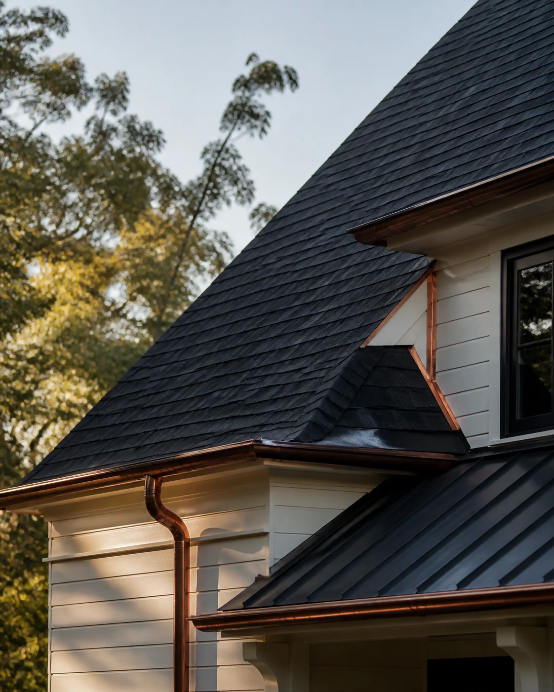 Architectural shingle roof and copper-accented gutter details